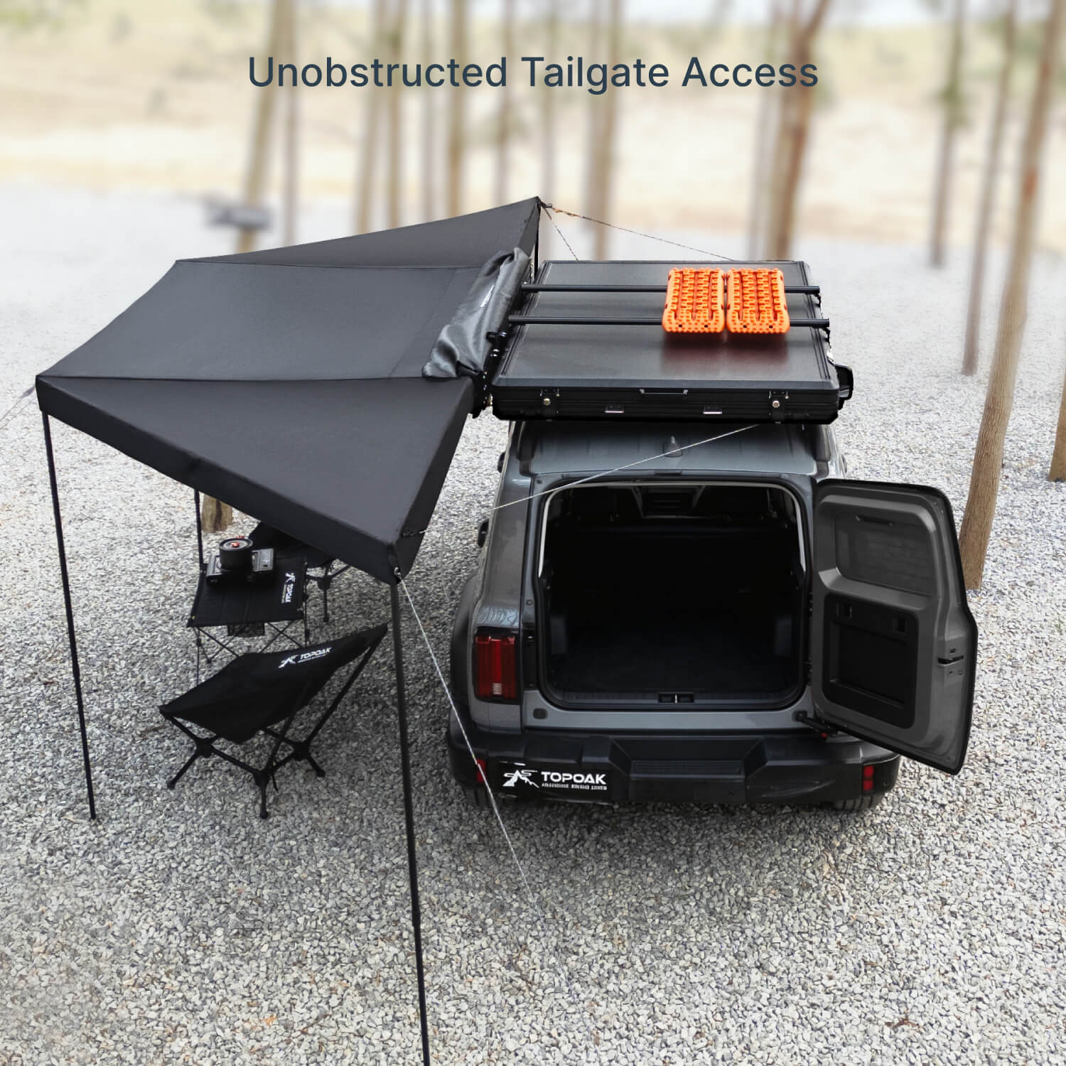 TOPOAK 180 degree car awning on SUV allowing full tailgate access with rear door open during camping setup
