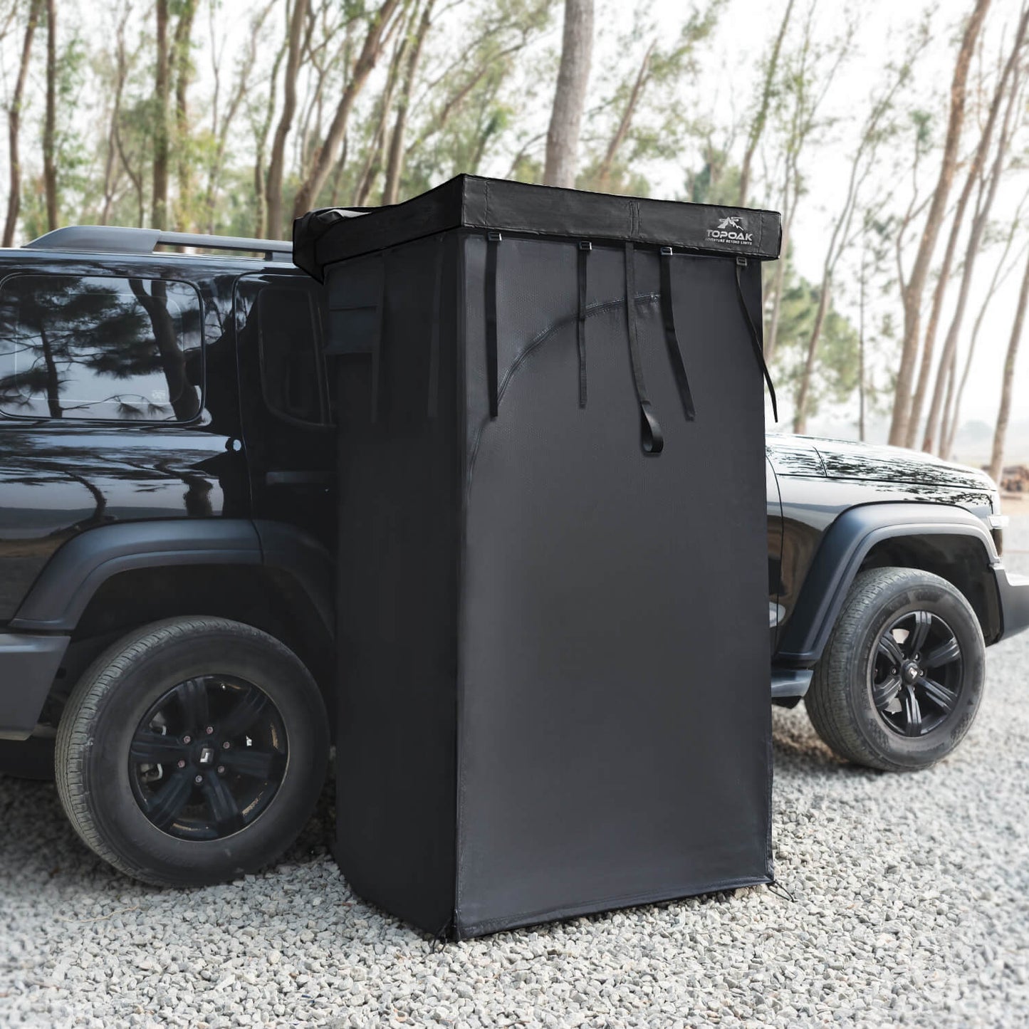Vehicle mounted awning shower room privacy tent attached to an SUV for overland camping