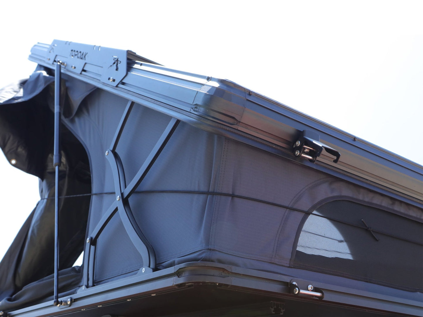 Front view of TOPOAK Nebula rooftop tent opened, showing its 10-inch closed height and sturdy structural frame for full extension and comfort.