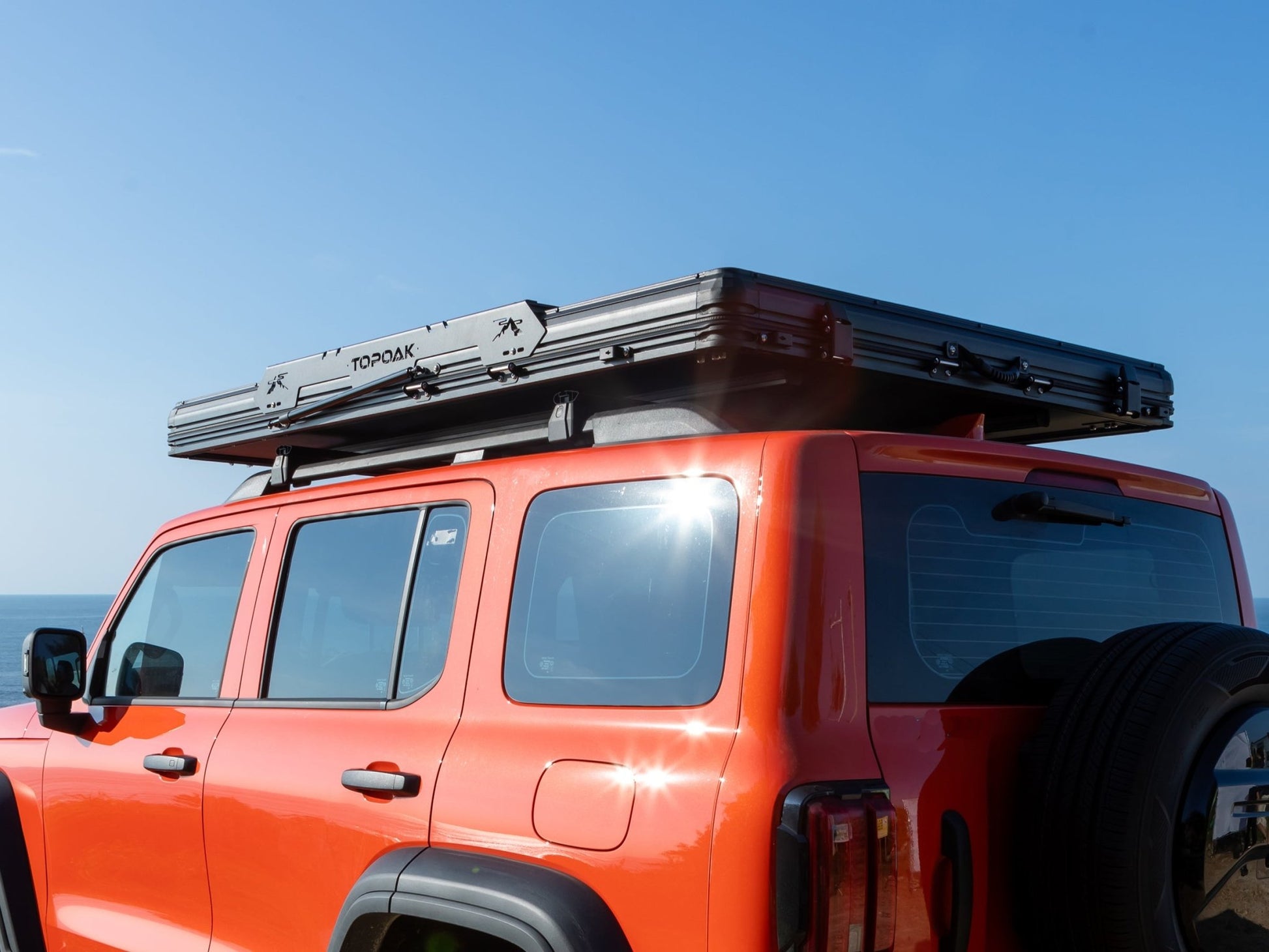 Rear side view of TOPOAK Nebula rooftop tent mounted on a vehicle, showing its low-profile closed design.