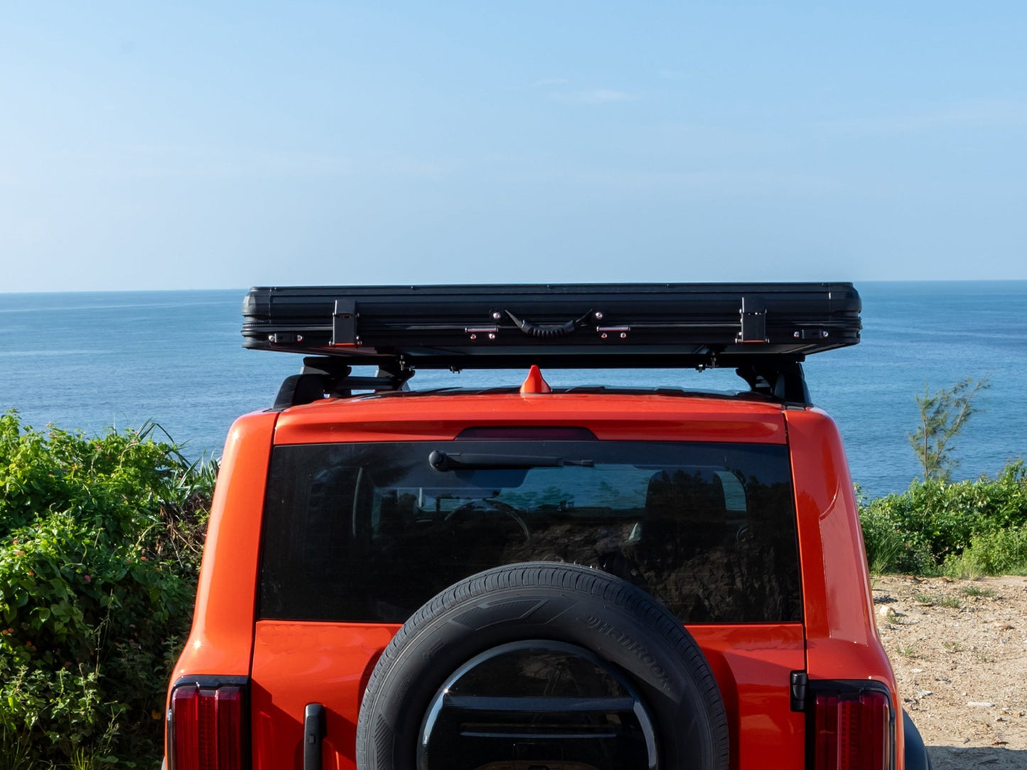 Rear view of TOPOAK Nebula rooftop tent mounted on a vehicle, showing its low-profile closed design.