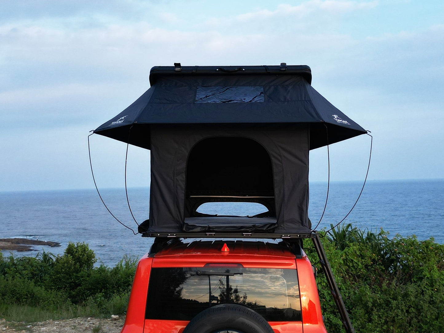 Rear view TOPOAK Nebula rooftop tent mounted on SUV, hard shell RTT for 4-season camping