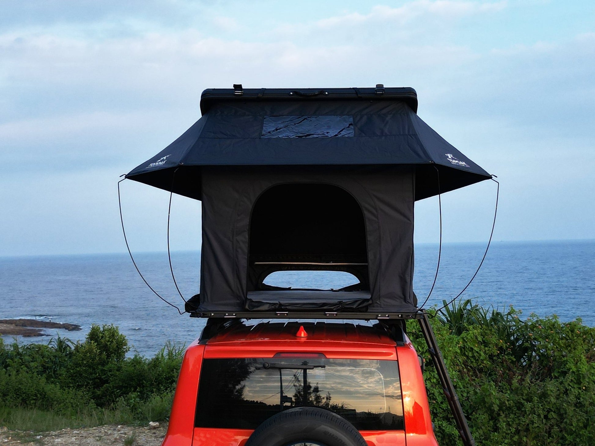 Rear view TOPOAK Nebula rooftop tent mounted on SUV, hard shell RTT for 4-season camping
