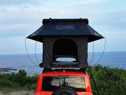 Rear view TOPOAK Nebula rooftop tent mounted on SUV, hard shell RTT for 4-season camping
