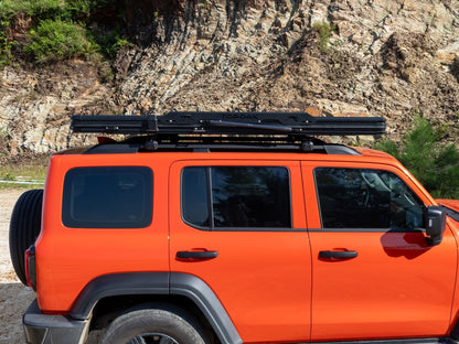 Side view of TOPOAK Nebula rooftop tent mounted on a vehicle, showing its low-profile closed design.
