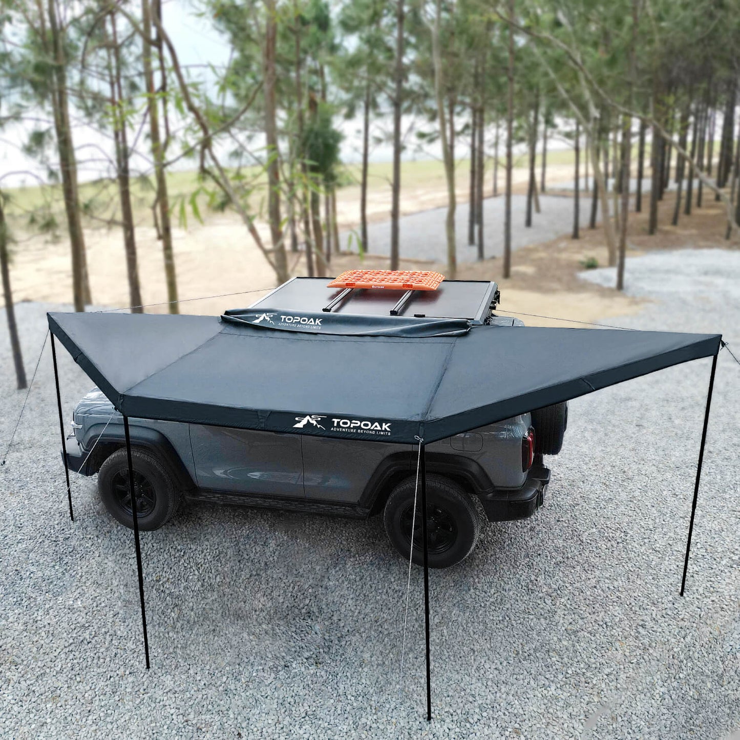 Topoak 180 degree overland awning mounted on a pickup truck providing large shade coverage for outdoor camping