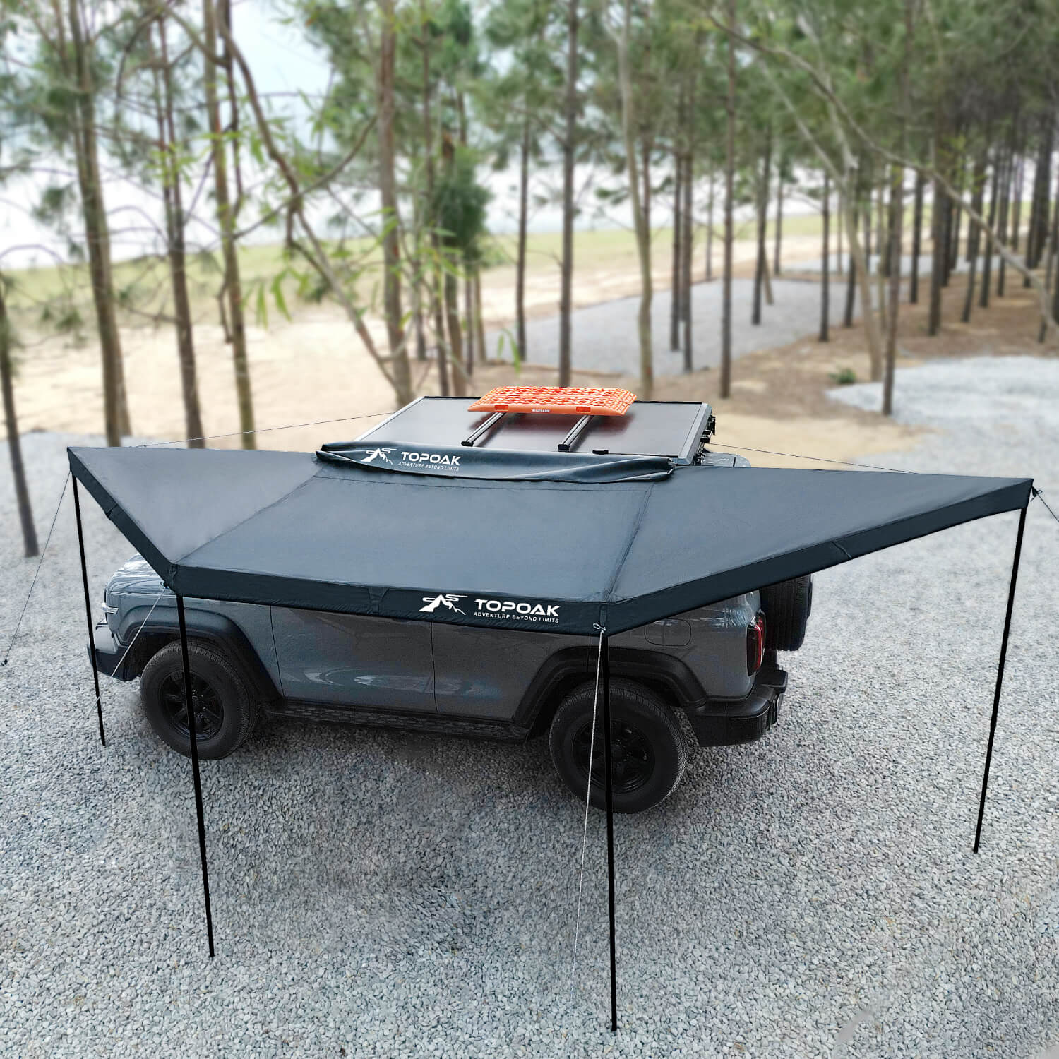 Topoak 180 degree overland awning mounted on a pickup truck providing large shade coverage for outdoor camping