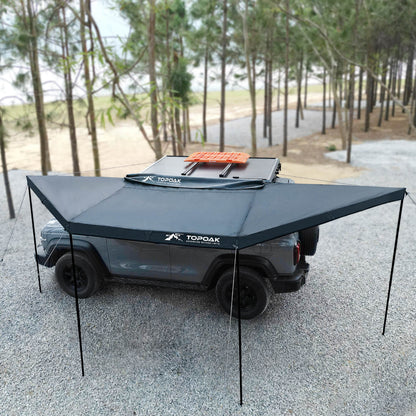 Topoak 180 degree overland awning mounted on a pickup truck providing large shade coverage for outdoor camping