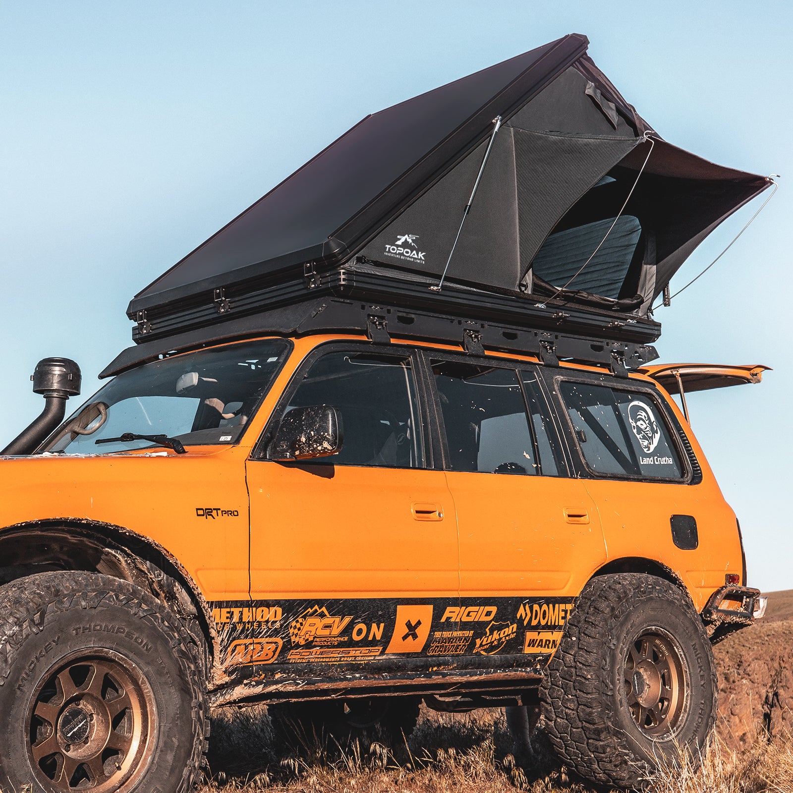 TOPOAK Stellar rooftop tent shown from a front angle, fully opened on a vehicle for overland camping