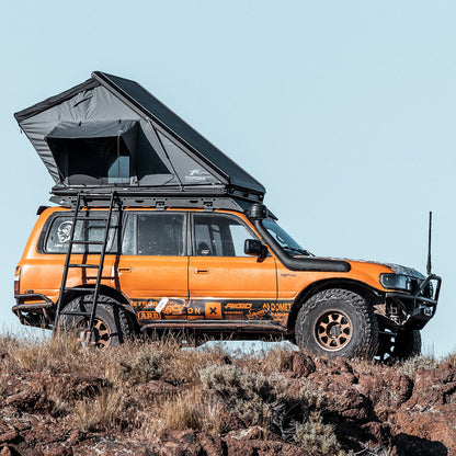 Side view of the TOPOAK Stellar rooftop tent mounted on a vehicle, fully opened for camping